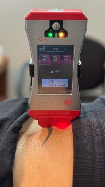 Close-up image of the Erchonia Cold Laser therapy being used on a patient at Path to Wellness Clinic of Chiropractic in Fleming Island, FL.
