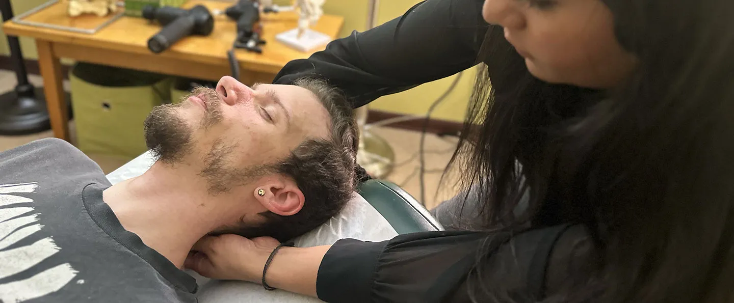 Dr. Chitra Rajendran examining a patient's neck