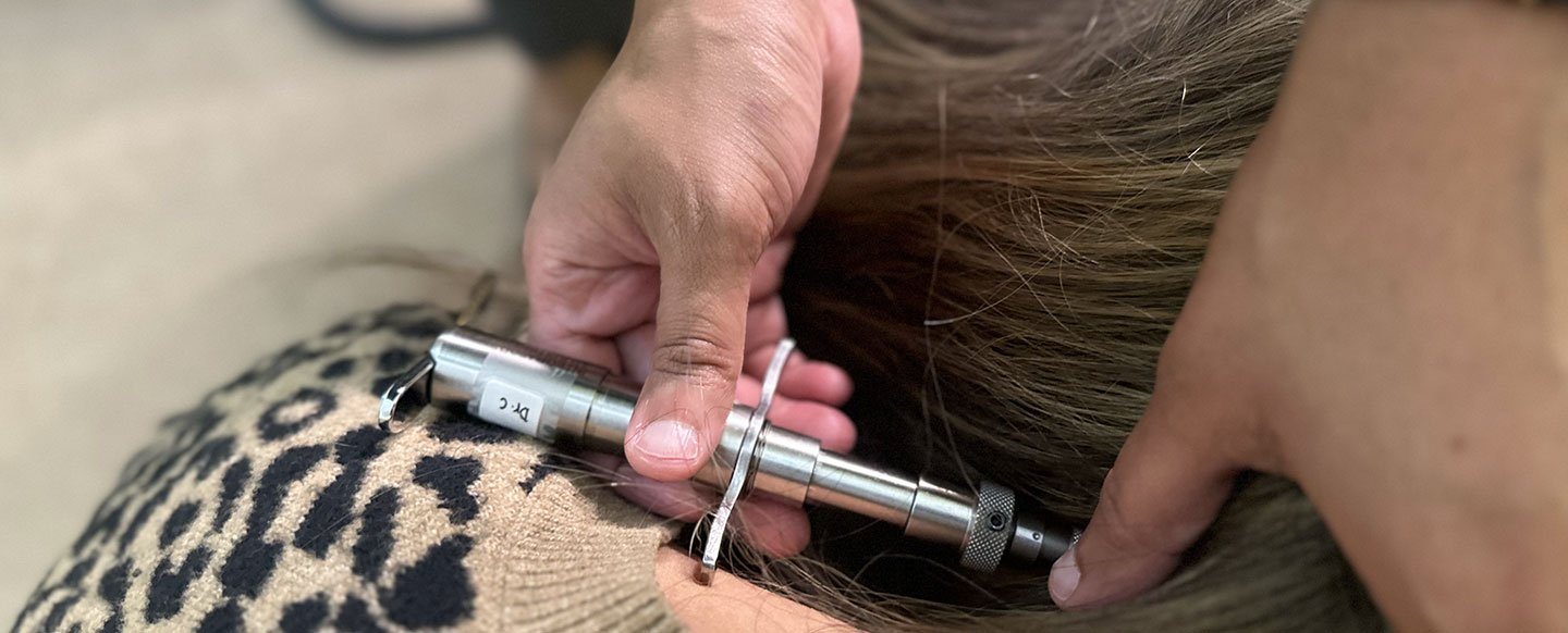 Some patient's who have metal rods in their backs cannot be physically adjusted by hand, so Dr. Chitra Rajendran is using the Torque Release Technique (TRT) tool to adjust this patient.